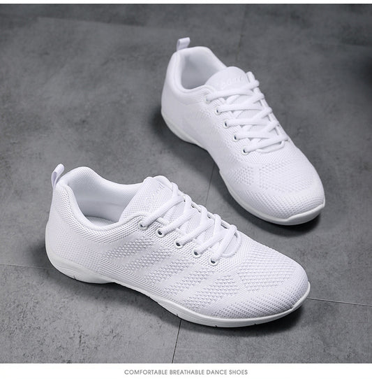 Pair of all-white lace-up cheerleading shoes with mesh upper