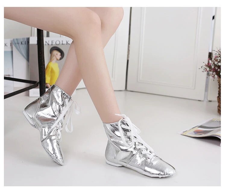 Close-up of silver metallic jazz boots showing ankle support and laces