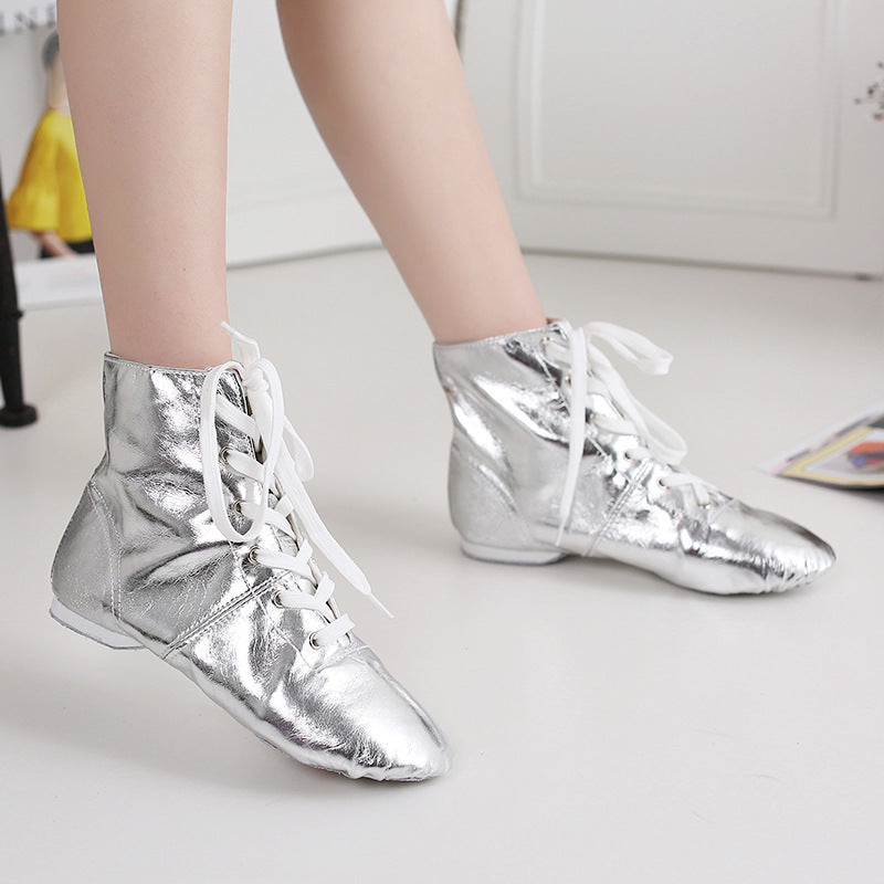 Shiny silver metallic high-top dance boots on model, front angle view