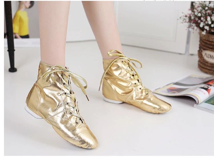 Three pairs of metallic jazz dance boots in black, gold, and silver displayed together