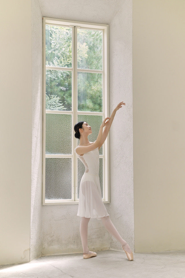 White floral lace ballet leotard close-up on model, cap sleeve and round neck
