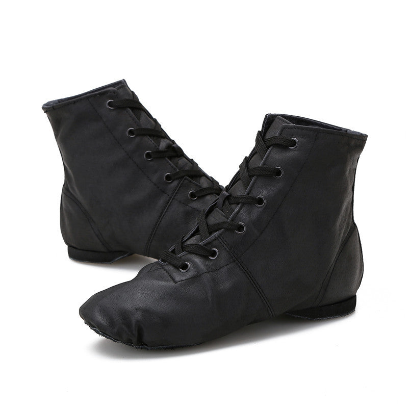 Pair of black high-top jazz dance boots with lace-up design, studio shot on white background