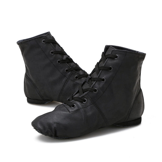 Pair of black high-top jazz dance boots with lace-up design, studio shot on white background