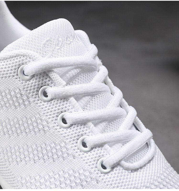 Close-up of breathable fly-knit mesh on white cheerleading shoes