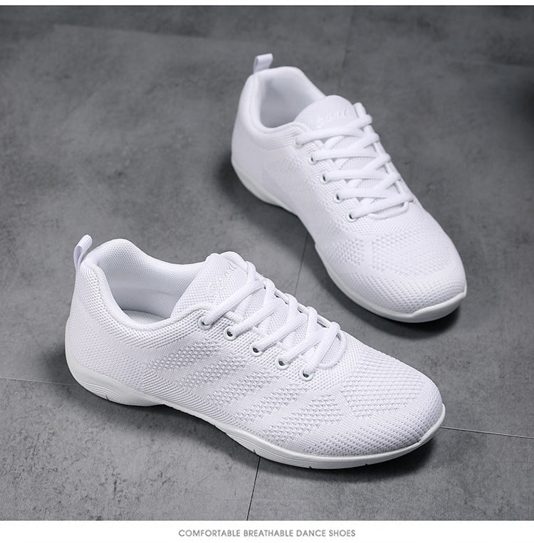 Pair of all-white lace-up cheerleading shoes with mesh upper