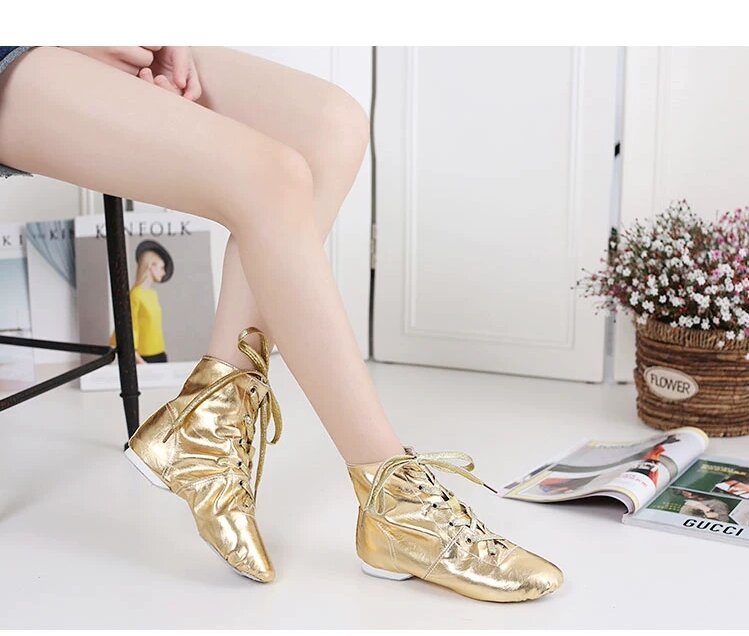 Three pairs of metallic jazz dance boots in black, gold, and silver displayed together