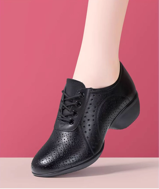 Flexible black dance shoe sole demonstration showing soft bendable material and non-slip texture