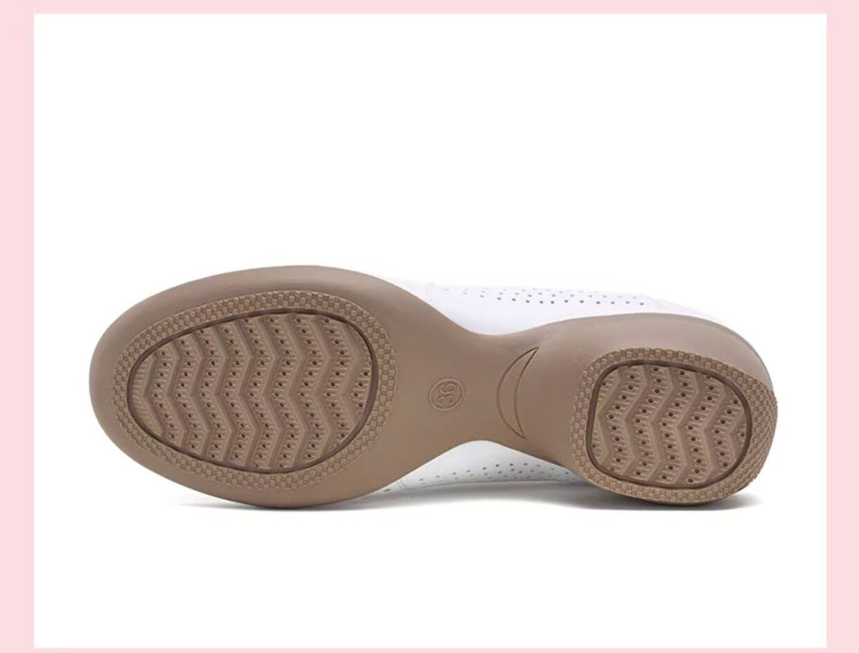 Detail shot of black dance shoe's padded collar and breathable perforations